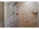 Tiled shower featuring a shower head and built in shelving at 23 Hunting Creek Dr, Marietta, GA 30068