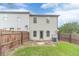 The property features a well-maintained backyard with a concrete patio area, and wooden fencing for privacy at 2500 Morgan Chase Dr, Buford, GA 30519