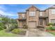 Inviting brick townhome with a one-car garage and meticulously landscaped front yard at 2500 Morgan Chase Dr, Buford, GA 30519