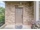 Stylish front door with a brick surround, decorative lighting, and a welcome mat at 2500 Morgan Chase Dr, Buford, GA 30519