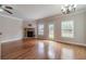 Bright living area with hardwood floors, stone fireplace, ceiling fan, and a view of the backyard at 2500 Morgan Chase Dr, Buford, GA 30519