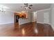 Open-concept living room with hardwood floors flowing into kitchen with black appliances at 2500 Morgan Chase Dr, Buford, GA 30519
