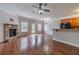 Open-concept living area featuring hardwood floors, a stone fireplace, and a view of the kitchen at 2500 Morgan Chase Dr, Buford, GA 30519