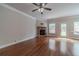 Spacious living room with hardwood floors, a ceiling fan, stone fireplace and natural light at 2500 Morgan Chase Dr, Buford, GA 30519