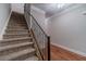 Carpeted staircase featuring iron railings and hardwood flooring in the entryway at 2500 Morgan Chase Dr, Buford, GA 30519