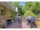 Enjoy outdoor dining on the spacious back deck with mature trees and a grill at 2575 Dobbs Nw Dr, Kennesaw, GA 30152