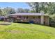 Expansive backyard with a deck, garden beds, and mature trees, offering a private retreat at 2575 Dobbs Nw Dr, Kennesaw, GA 30152