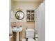 Small bathroom featuring a pedestal sink, a round mirror, and a shower with a curtain at 2575 Dobbs Nw Dr, Kennesaw, GA 30152