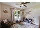 Cozy bedroom with a chair, rug, window, and play kitchen with accessories at 2575 Dobbs Nw Dr, Kennesaw, GA 30152