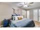 Comfortable bedroom featuring a ceiling fan, a window and a bedside table with drawers at 2575 Dobbs Nw Dr, Kennesaw, GA 30152