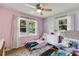 bedroom features matching beds, bright walls, and large windows overlooking the yard at 2575 Dobbs Nw Dr, Kennesaw, GA 30152