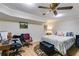 Bedroom with a desk, 2 chairs, bed, ottoman, and colorful accents at 2575 Dobbs Nw Dr, Kennesaw, GA 30152