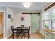 Bright dining area with a modern table, sliding barn door, and natural light at 2575 Dobbs Nw Dr, Kennesaw, GA 30152