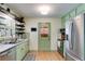Stylish kitchen with stainless steel appliances, green cabinets and light countertops at 2575 Dobbs Nw Dr, Kennesaw, GA 30152