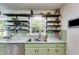 The kitchen features open shelving, stainless steel appliances and green cabinets at 2575 Dobbs Nw Dr, Kennesaw, GA 30152