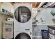 Modern laundry room featuring a washer and dryer combo and shelving with supplies at 2575 Dobbs Nw Dr, Kennesaw, GA 30152