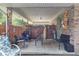 Relax on the covered patio with outdoor seating and a charming brick surround at 2575 Dobbs Nw Dr, Kennesaw, GA 30152