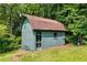 Charming backyard storage shed with double doors and a window, nestled among trees at 2575 Dobbs Nw Dr, Kennesaw, GA 30152