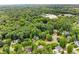 An aerial view of a neighborhood showing lush landscaping and mature trees surrounding the homes at 4020 Devereux Chase, Roswell, GA 30075