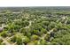 A lush, green neighborhood is captured in an aerial view, showcasing tree-lined streets and well-maintained homes at 4020 Devereux Chase, Roswell, GA 30075