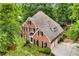 Aerial view of brick home with manicured landscaping, a private backyard, and a two-car garage at 4020 Devereux Chase, Roswell, GA 30075