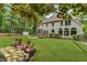 Beautiful backyard with a stone patio, lush lawn, hammock, mature trees, and plenty of space for outdoor enjoyment at 4020 Devereux Chase, Roswell, GA 30075