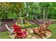 Serene backyard with a waterfall feature surrounded by mature trees and outdoor seating area at 4020 Devereux Chase, Roswell, GA 30075
