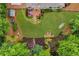 Aerial view of backyard with stone patio, water feature, hammock, storage shed, and mature landscaping at 4020 Devereux Chase, Roswell, GA 30075