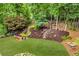 Overhead shot of the backyard featuring a waterfall feature, stone pathways, mature trees, and outdoor seating around a fire pit at 4020 Devereux Chase, Roswell, GA 30075