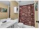 Bathroom with decorative shower curtain, vanity with sink and storage, and a large mirror at 4020 Devereux Chase, Roswell, GA 30075