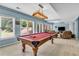 Finished basement billiards room with an adjacent living room, comfortable seating, and ample light at 4020 Devereux Chase, Roswell, GA 30075