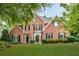 Stunning brick home with manicured lawn and mature trees exudes curb appeal at 4020 Devereux Chase, Roswell, GA 30075