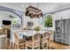 Charming kitchen boasts white cabinetry, island with seating, stainless appliances, and a view to the Gathering room at 4020 Devereux Chase, Roswell, GA 30075