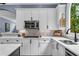 Well-lit kitchen with white cabinets, subway tile backsplash, and stainless steel appliances at 4020 Devereux Chase, Roswell, GA 30075