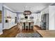 Bright, open kitchen with stainless steel appliances, white cabinetry and a large central island with seating at 4020 Devereux Chase, Roswell, GA 30075