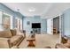 Finished basement living area boasts comfortable seating, natural light, and an adjacent billiards room at 4020 Devereux Chase, Roswell, GA 30075