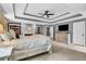 Spacious main bedroom includes trey ceilings, a ceiling fan, and a decorative cabinet for lots of space at 4020 Devereux Chase, Roswell, GA 30075