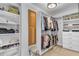 Well-organized walk-in closet with shelving and hanging racks provides lots of storage at 4020 Devereux Chase, Roswell, GA 30075