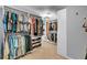 Large walk-in closet includes custom shelving and hanging storage for optimal organization at 4020 Devereux Chase, Roswell, GA 30075