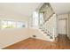 Bright foyer with hardwood floors and natural light, showcasing the staircase at 2325 E Hill Way, Norcross, GA 30071