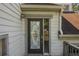 Close-up of the front door featuring decorative glass and detailed trim work at 2325 E Hill Way, Norcross, GA 30071