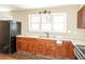 Bright kitchen features countertops, a black refrigerator, and stainless steel sink at 2325 E Hill Way, Norcross, GA 30071