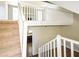 Open-concept living space with stairs leading to an upstairs landing and fireplace at 2325 E Hill Way, Norcross, GA 30071