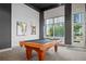 Inviting game room featuring a classic pool table, cue rack, and window with natural light, creating a relaxed atmosphere at 250 Pharr Ne Rd # 1814, Atlanta, GA 30305