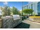 Outdoor stainless steel grill in community area with stone accents and lush landscaping against an upscale building backdrop at 250 Pharr Ne Rd # 1814, Atlanta, GA 30305
