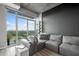 Modern living room with large windows offering stunning city views, stylish grey sofa, and sleek decor at 250 Pharr Ne Rd # 1814, Atlanta, GA 30305
