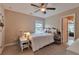 Bedroom featuring a ceiling fan, carpet flooring, closet, and a window at 4708 Tiger Blvd, Duluth, GA 30096