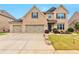 Charming brick home featuring a three-car garage and professionally landscaped front yard at 4708 Tiger Blvd, Duluth, GA 30096