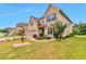 Lovely home with three-car garage and an inviting front yard with manicured landscaping at 4708 Tiger Blvd, Duluth, GA 30096