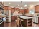 Kitchen features granite countertops, stainless steel appliances, and a large island with seating at 4708 Tiger Blvd, Duluth, GA 30096